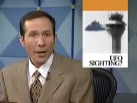 CLTV presenter beside television artwork showing a saucer and control tower