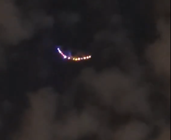 A curved row of colored lights surrounded by clouds
